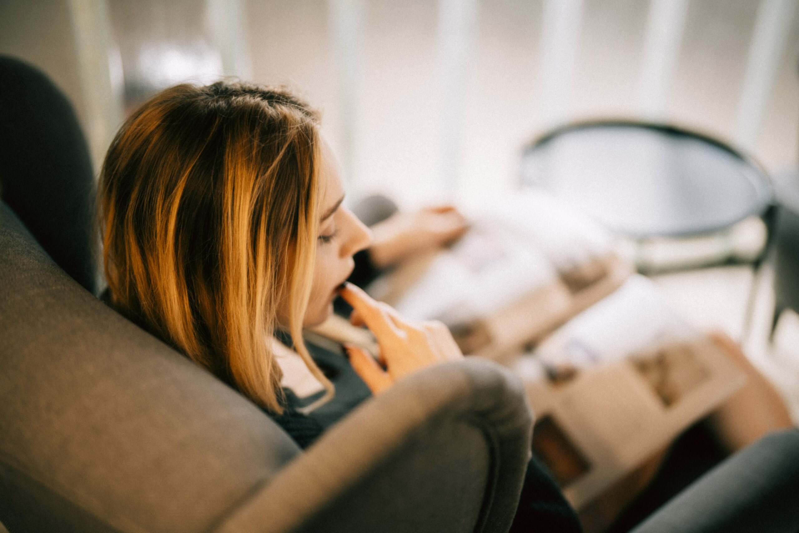a picture of woman sitting and reading a book